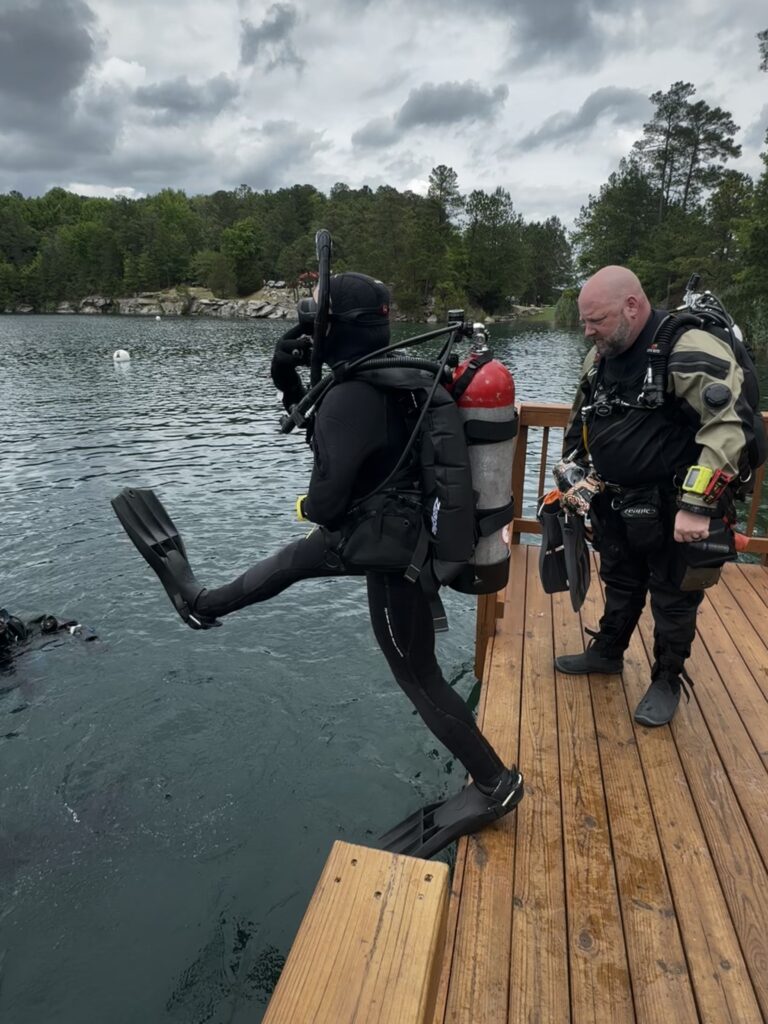 diver jumping into water